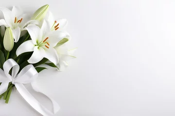 Fotobehang White lily bouquet with ribbon on white background.Funeral Concept © Rudsaphon