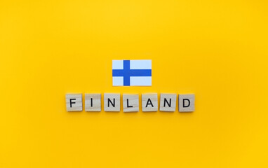 December 6, Independence Day of Finland, the flag of Finland, a minimalistic banner with an inscription in wooden letters