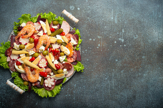 Close up of Fiambre, salad of Guatemala, Mexico and Latin America top view with cold cuts, shrimps, pickled vegetables. Festive dish for All Saints Day (Day Of The Dead) celebration, space for text.