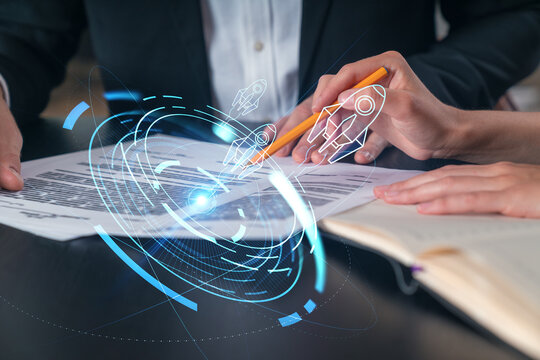Businesspeople in formal wear taking notes signing contract at office workplace. Concept of important working moments, document sign, working process, concentration. Hands shot. Start up hologram