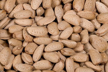 Fresh and tasty almond nuts background, perfect background for your culinary creations, detail of the texture of the dry fruits