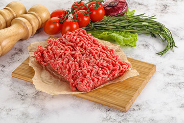 Raw minced beef meat on cutting board