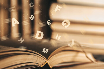 dyslexia concept. Flying tangled letters in the air. Antique book with open pages - obrazy, fototapety, plakaty