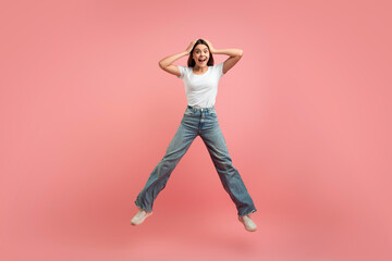 Crazy Sales. Funny Cute Teen Girl Jumping Over Pink Studio Background