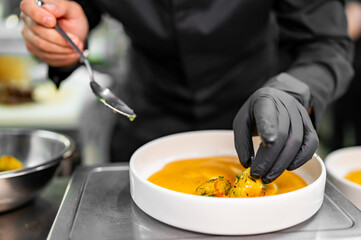 Chef cook hand cooking potato salad at the restaurant kitchen