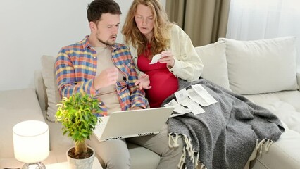 A couple enters expenses from receipts into a financial app on a laptop. family is expecting a child. Pregnant woman discussing budget with husband while buying goods or services online. Family money - Powered by Adobe