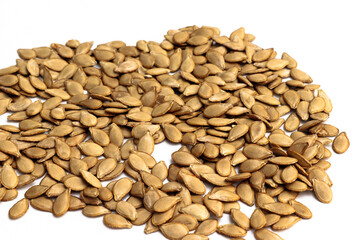 A layer of pumpkin seeds on a white background.