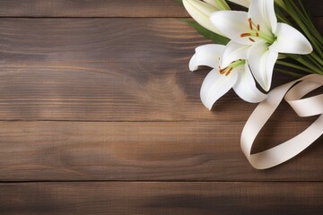 Fototapeta na wymiar White lily flowers on wooden background. Top view with copy space.Funeral Concept