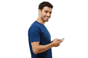 Young attractive man looking and smiling at the camera while texting, using mobile phone