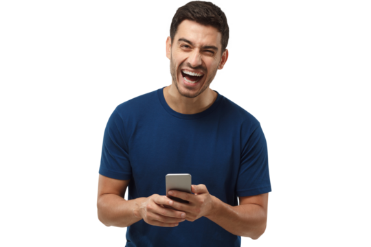 Portrait of handsome young man in blue t-shirt, holding phone, looking at camera and laughing