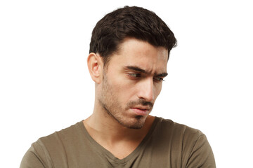 Portrait of offended young man, looking down, feeling guilty of relationship problems, stressed