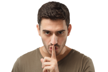 Close-up shot of young man with shhh gesture, asking for silence or to be quiet