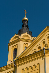 Nizhny Novgorod, Russia, July 6, 2023. Fragment of the facade of the Alexander Nevsky Cathedral with a tower and dome.