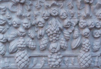 Fragment of a stucco floral pattern of an old church.