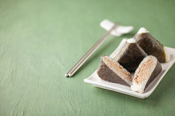 Korean triangle kimbap Samgak made with nori, rice and tuna fish. Copy space