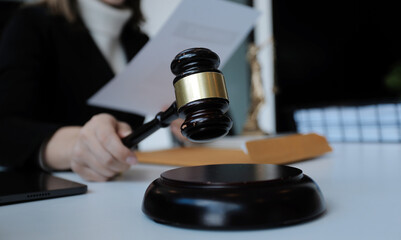 Male lawyer working with contract papers and wooden gavel on tabel in courtroom. justice and law ,attorney, court judge, concept.