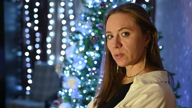 Amazing holiday moments: Happy woman posing on firtree background at home