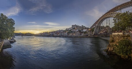 Fototapeta premium Panoramic view over Porto from the bank of Douro River during sunset