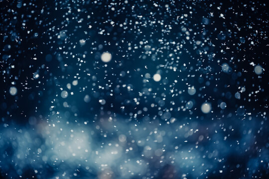 Winter snowfall overlays dark background with defocused white circles texture 
