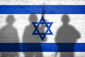 Flag of Israel painted on the brick wall with soldiers shadows. Gaza and Israel conflict. Terrorist...