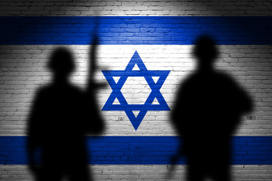 Flag of Israel painted on the brick wall with soldiers shadows. Gaza and Israel conflict. Terrorist organizations hezbollah and hamas
