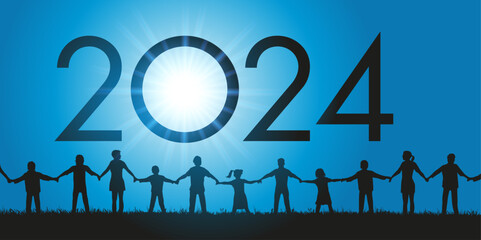 Un groupe d’hommes et de femmes de tous les âges ainsi que des enfants se donnent la main en signe de fraternité pour l’arrivée de l’année 2024.