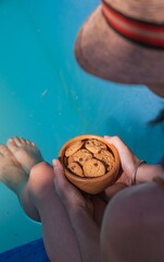 Mujer comiendo galletas con chips de chocolate frente a una piscina