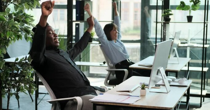 Office workers come together to celebrate a successful achievement right at their workplace. The scene captures the joy and camaraderie among colleagues as they acknowledge their accomplishments.