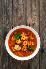 Louisiana soup gumbo with shrimps, chorizo and white rice on wooden table 