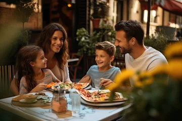 Fotobehang A cheerful family gathers at a restaurant, relishing a delightful meal, bonding with love and togetherness. © Andrii Zastrozhnov