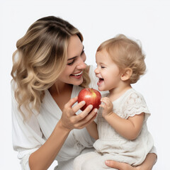 Fototapeta premium young mother feeds her daughter an apple.