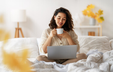 woman wearing warm clothes is using laptop