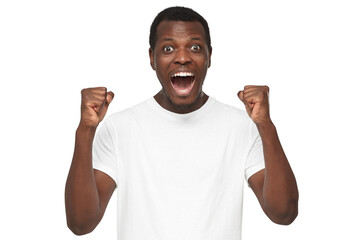 Shouting african american man celebrating win of his team, clenching fists in joyful euphoria as if...