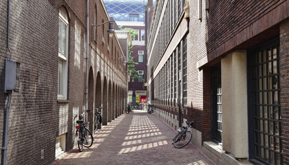 street in the old town of amsterdam, bicycles in alley