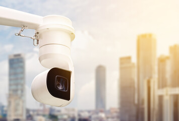 Modern public CCTV cameras with blurred city building background. Intelligent reccording cameras...