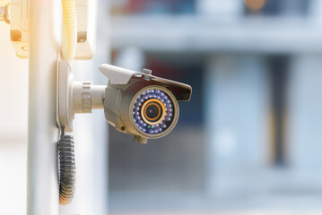 Modern public CCTV cameras with blurred building background.
