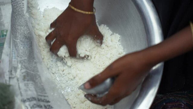 Making traditional rice cake called Bhapa Pitha, a soft and syrupy rice cake steamed to perfection, featuring coconut and jaggery for a deliciously sweet taste