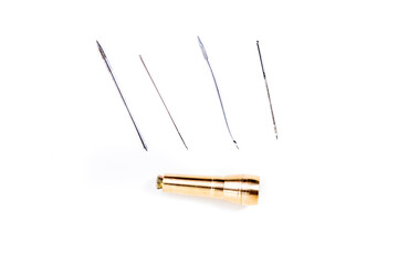 Brass leather awl punch kit with various tipped needles top down view