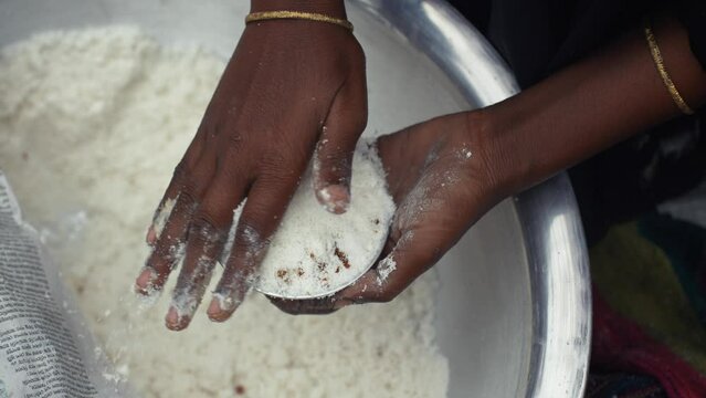 Making traditional rice cake called Bhapa Pitha, a soft and syrupy rice cake steamed to perfection, featuring coconut and jaggery for a deliciously sweet taste