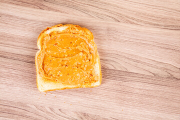 Peanut butter toast on a wooden cutting board
