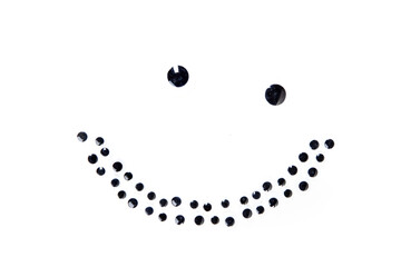 Lopsided smile face made of round black dots isolated over white
