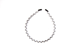 Fototapeta premium Black metal squiggle hair band isoalted over white top down