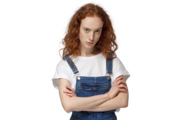 Angry redhead girl, evil young ginger woman looking at camera with anger, standing with arms crossed