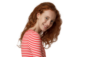 Young redhead woman turning shoulder to camera, smiling happily with her loose curly hair falling down