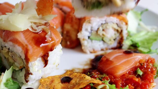 Overhead japanese sushi food. Maki ands rolls with salmon, shrimp, crab and avocado. Top view of assorted sushi, all you can eat menu. Rainbow sushi roll, uramaki, hosomaki and nigiri. 