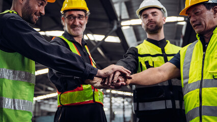 Obraz premium Team engineers and foreman stack hand and shake hands to show success at factory machines. Mechanical Team Operating Machinery.