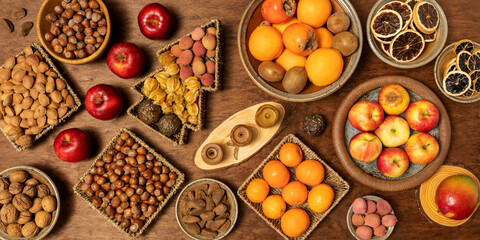 Selection of nuts and fruits on a table. Healthy snacks. Top view.
