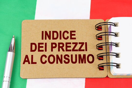 On the flag of Italy lies a pen and a notebook with the inscription - consumer price index