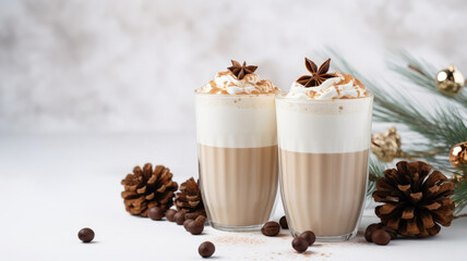 Two glasses of cinnamon latte coffee and gingerbread cookie, pine cone and fir branch for Christmas. High quality photo
