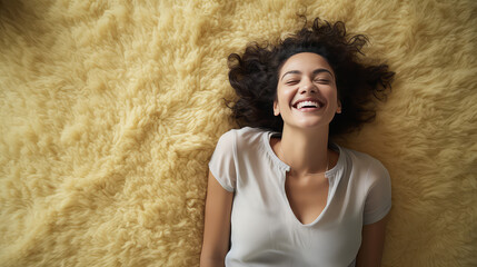 Smiling young woman lies on the floor of her home on a fluffy clean carpet. Creative concept of cleaning, washing vacuum cleaner for carpets and upholstered furniture, cozy fittings.  - obrazy, fototapety, plakaty